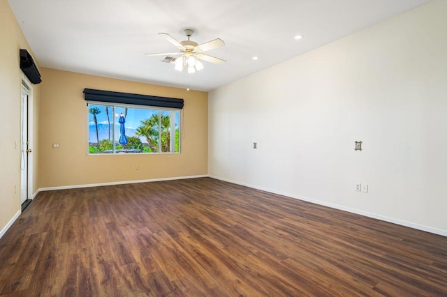 empty room featuring ceiling fan and dark hardwood / wood-style flooring