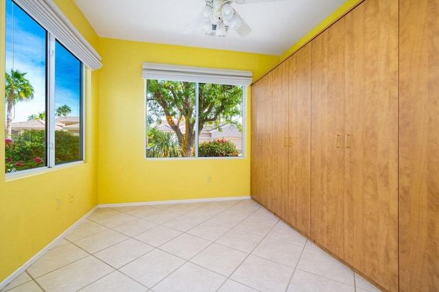 spare room featuring ceiling fan and light tile patterned flooring