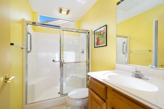 bathroom with vanity, toilet, tile patterned flooring, and an enclosed shower