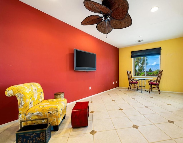 sitting room with ceiling fan and tile patterned floors