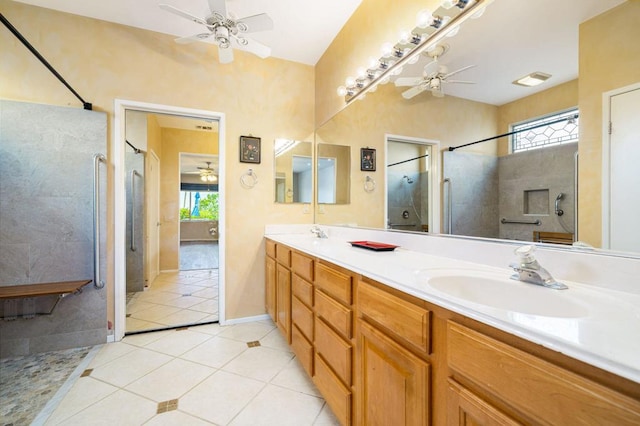 bathroom featuring vanity, tile patterned flooring, a wealth of natural light, and tiled shower