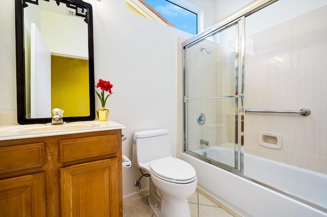 full bathroom with tile patterned floors, toilet, vanity, and shower / bath combination with glass door