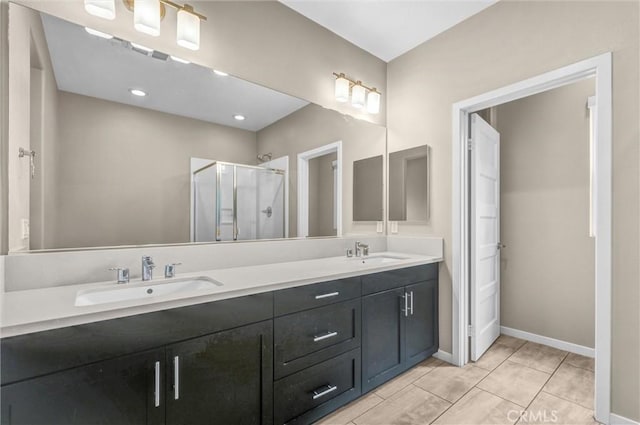 bathroom featuring a shower with shower door, tile patterned floors, and vanity