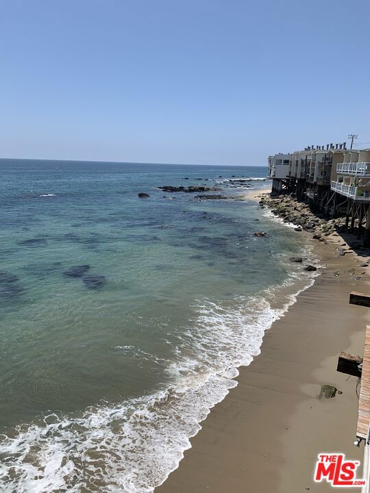 property view of water featuring a beach view