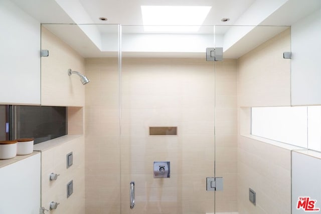 bathroom featuring a shower with door