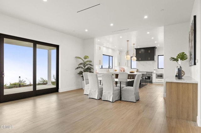 dining area featuring light wood-type flooring