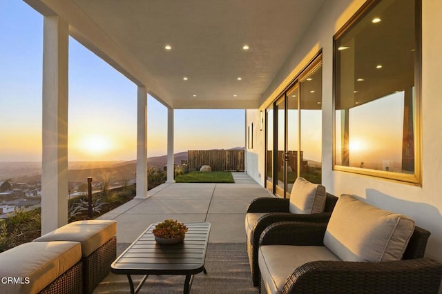 patio terrace at dusk featuring an outdoor living space