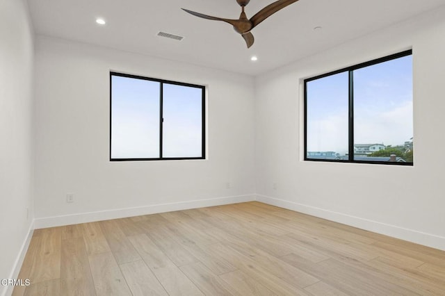 unfurnished room with light hardwood / wood-style floors, plenty of natural light, and ceiling fan