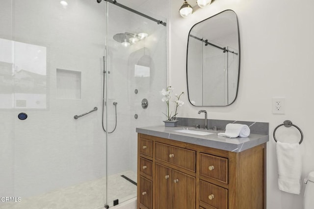 bathroom with a shower with door and vanity