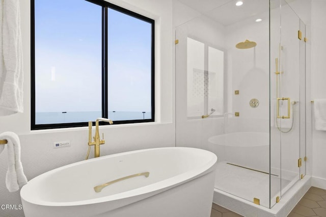 bathroom featuring separate shower and tub, tile patterned floors, and a healthy amount of sunlight