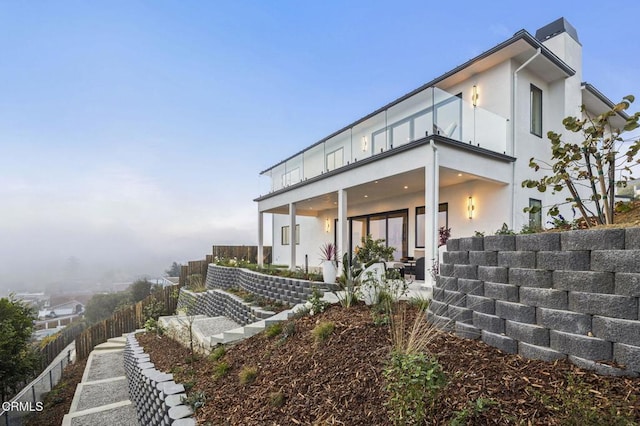 rear view of house featuring a balcony