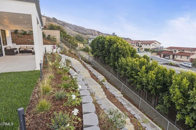 view of yard with a patio area, a mountain view, and an outdoor living space