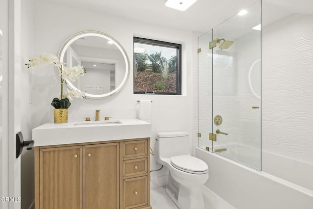 full bathroom featuring combined bath / shower with glass door, vanity, and toilet