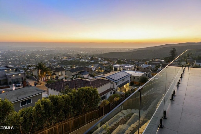 aerial view at dusk featuring a mountain view