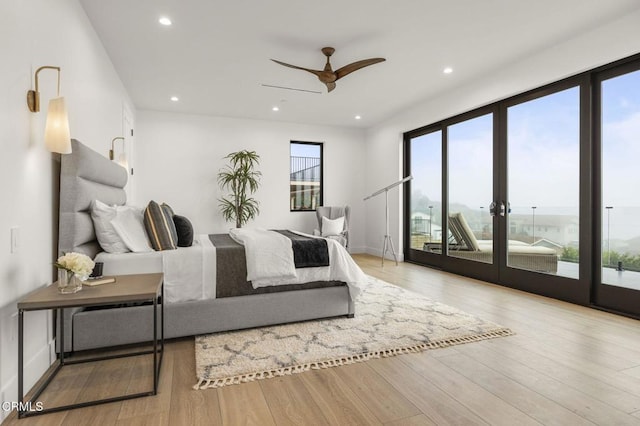 bedroom with ceiling fan, light hardwood / wood-style floors, access to outside, and french doors