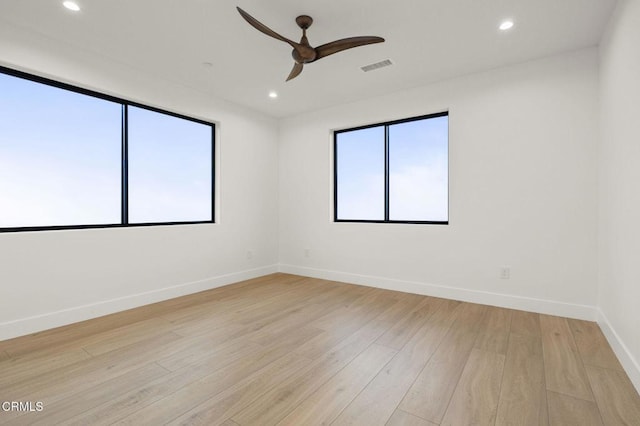 spare room featuring light hardwood / wood-style flooring and ceiling fan