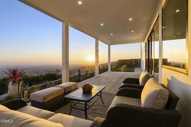 patio terrace at dusk featuring outdoor lounge area