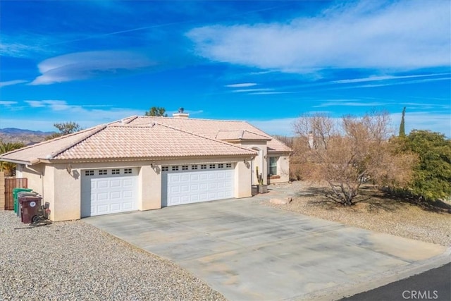 8550 Condalia Ave, Yucca Valley, CA 92284 - single story home featuring stucco siding, a tiled roof, driveway, and an attached garage