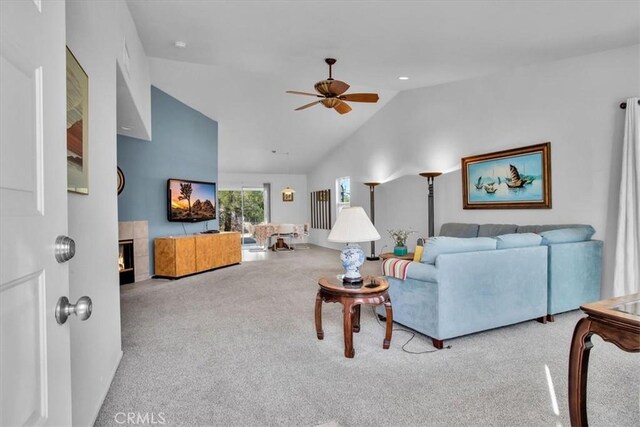 8550 Condalia Ave, Yucca Valley, CA 92284 - carpeted living room featuring ceiling fan, lofted ceiling, and a tiled fireplace