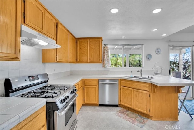 8550 Condalia Ave, Yucca Valley, CA 92284 - kitchen featuring stainless steel appliances, under cabinet range hood, plenty of natural light, a peninsula, and recessed lighting