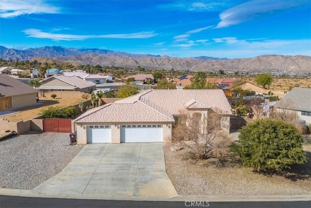 view of front of home with a mountain view and a garage