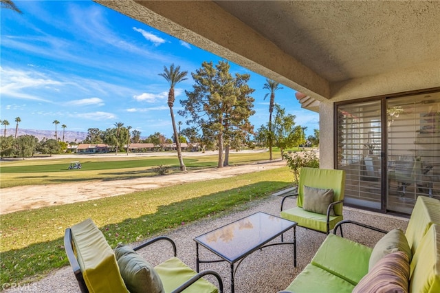 view of patio with a mountain view and an outdoor living space