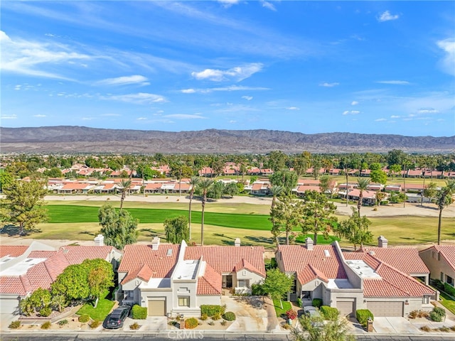 aerial view with view of golf course, a residential view, and a mountain view