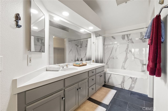 bathroom featuring a combined bath / shower with marble appearance and vanity