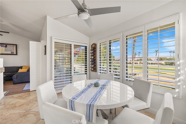 dining area featuring vaulted ceiling and a ceiling fan