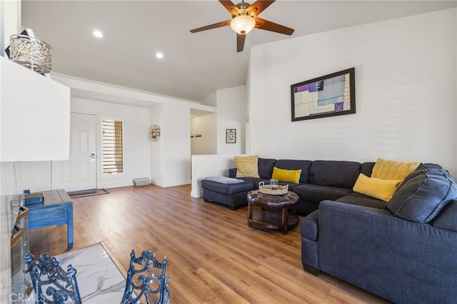 living area featuring recessed lighting, a ceiling fan, vaulted ceiling, light wood-type flooring, and baseboards