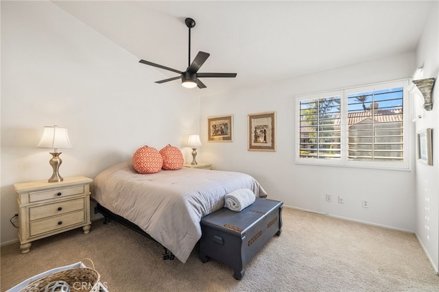 carpeted bedroom with a ceiling fan and baseboards