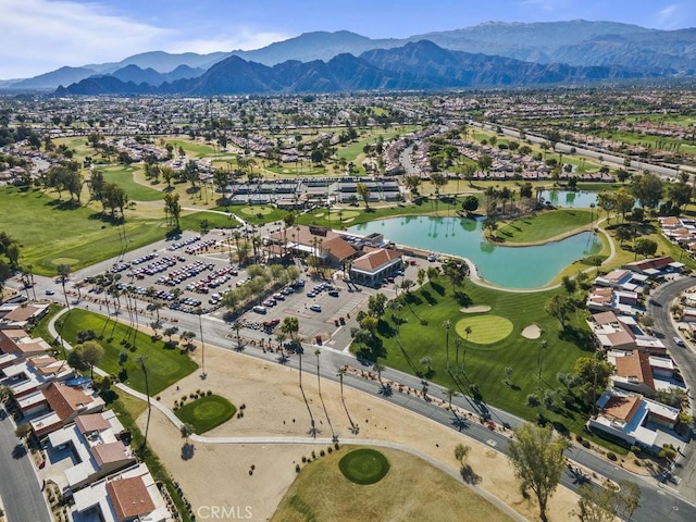 birds eye view of property featuring view of golf course and a water and mountain view