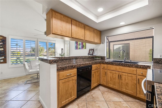 kitchen featuring a peninsula, a sink, stainless steel electric stove, dishwasher, and a tray ceiling