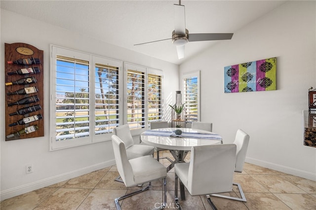 dining space featuring vaulted ceiling, ceiling fan, light tile patterned floors, and baseboards