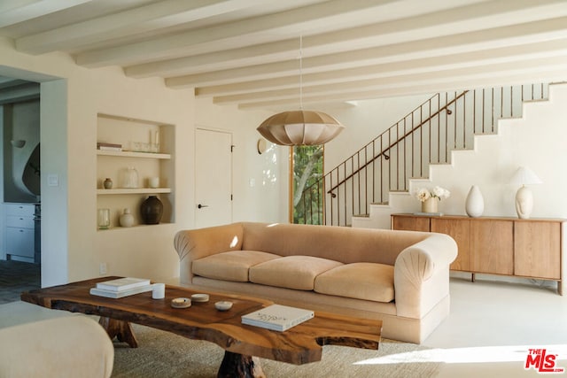 living room with beamed ceiling and carpet floors