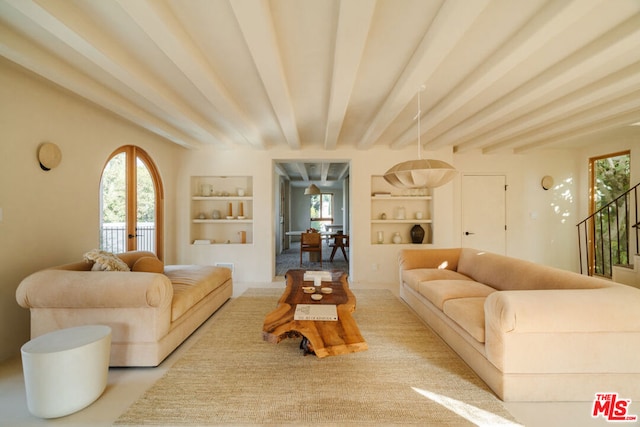 living room featuring beam ceiling, french doors, and built in shelves