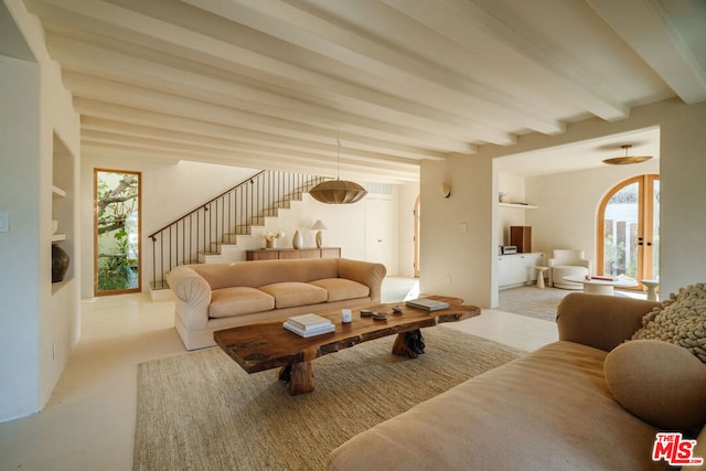 living room with beamed ceiling and plenty of natural light