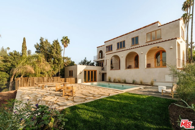 back of property with a patio and a balcony