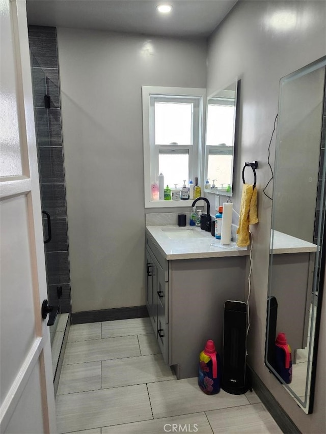 bathroom featuring vanity and a shower with shower door