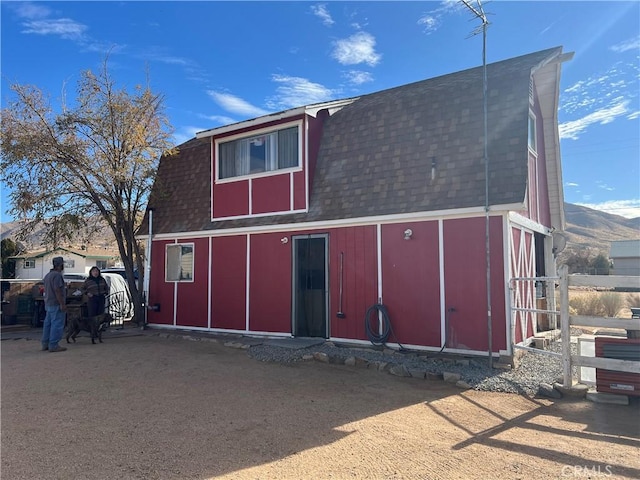 back of house with a mountain view