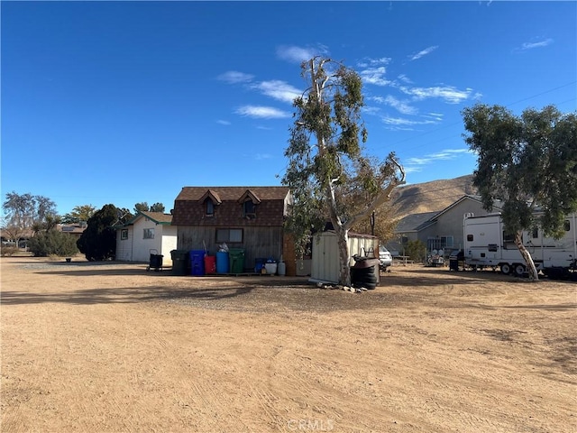 back of house with a mountain view