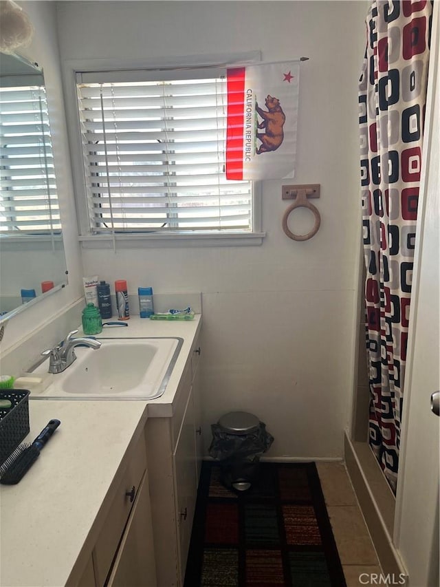 bathroom featuring a shower with shower curtain, tile patterned flooring, and vanity