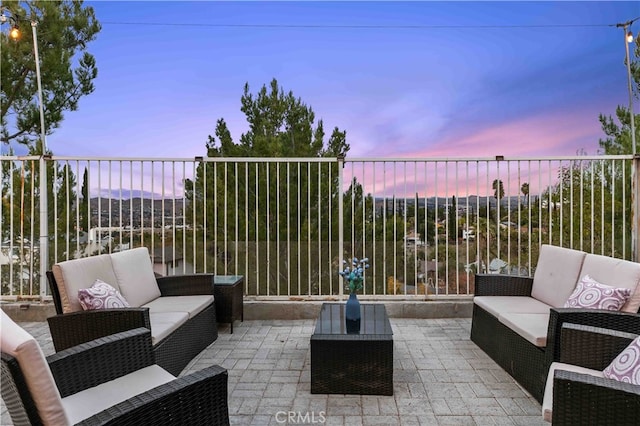 patio terrace at dusk featuring outdoor lounge area