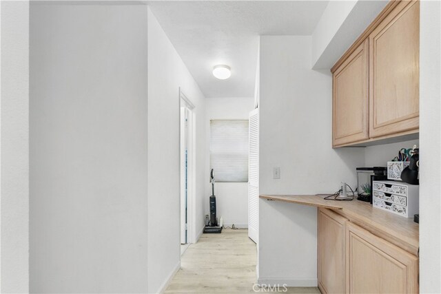 interior space featuring light brown cabinets and light hardwood / wood-style flooring