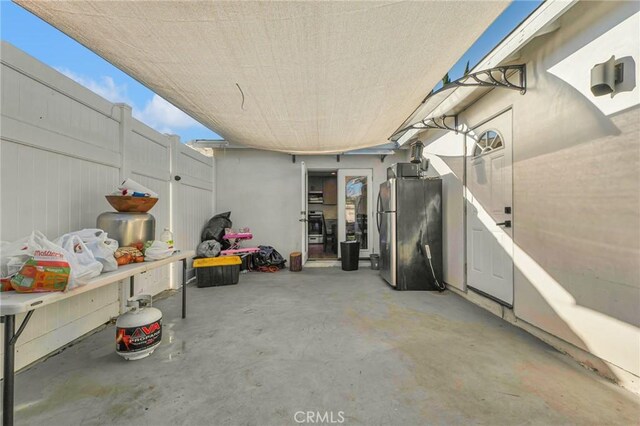 basement with stainless steel fridge