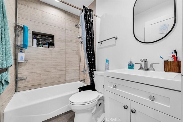 full bathroom featuring vanity, shower / bathtub combination with curtain, and toilet