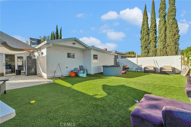 back of house featuring a yard and a patio