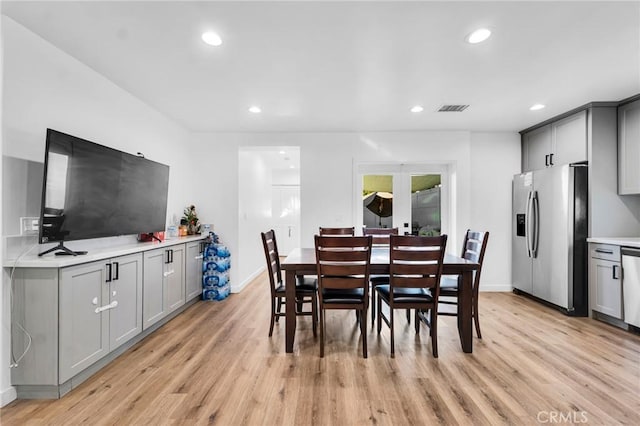 dining space with light hardwood / wood-style flooring