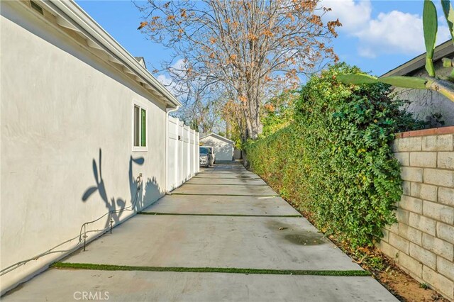 view of property exterior with a patio area