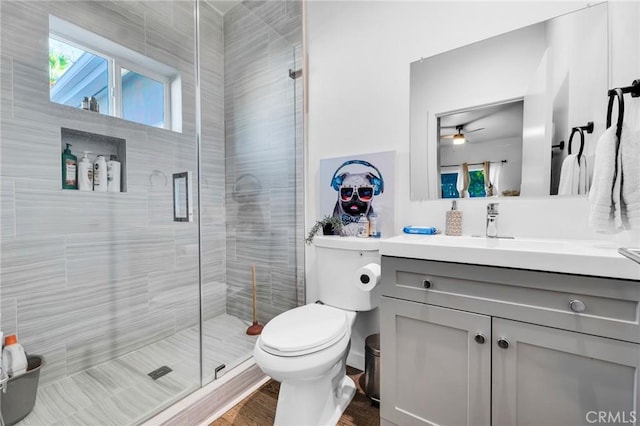 bathroom with vanity, a shower with shower door, wood-type flooring, and toilet